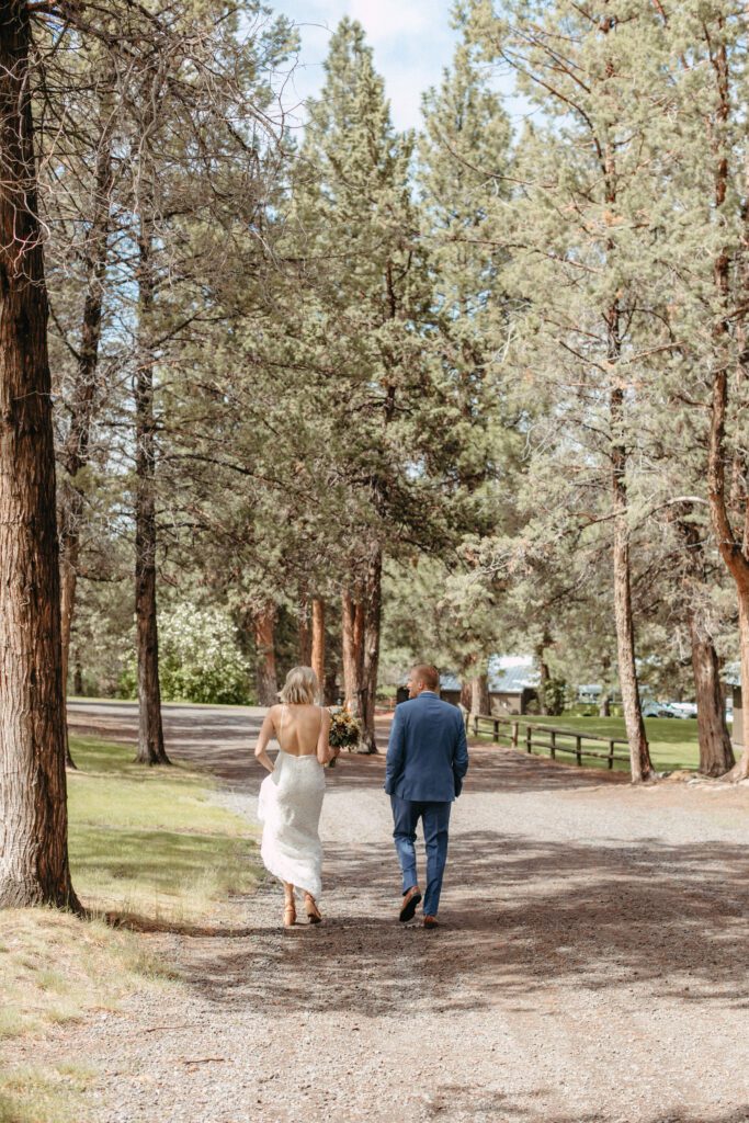 Do I really need a wedding coordinator? Couple walking on their wedding day